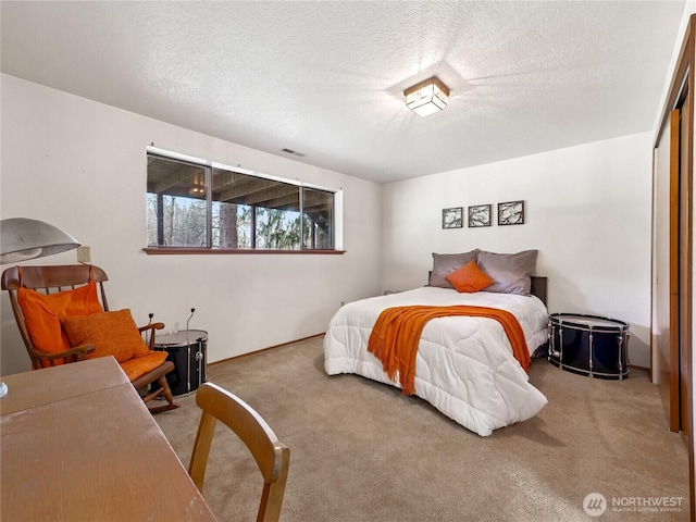 carpeted bedroom featuring a textured ceiling