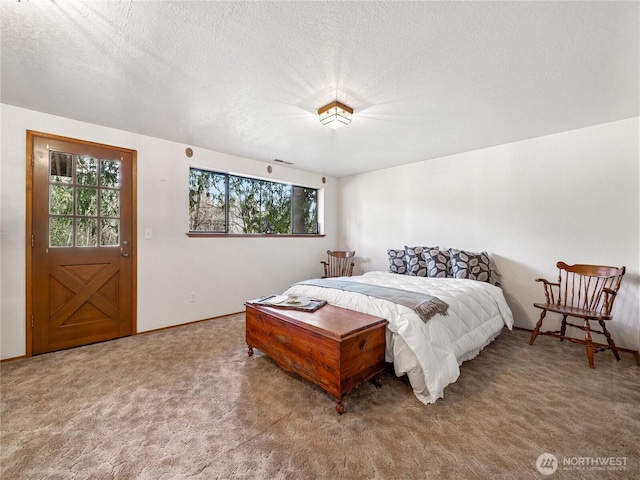 carpeted bedroom featuring a textured ceiling