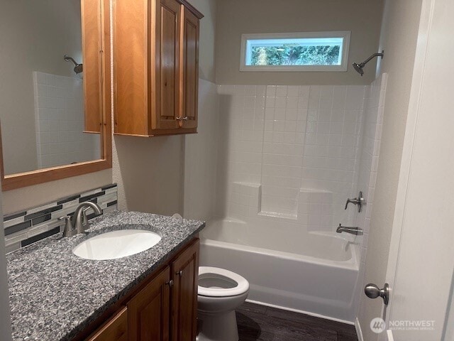 full bath with vanity, wood finished floors, toilet, and bathtub / shower combination