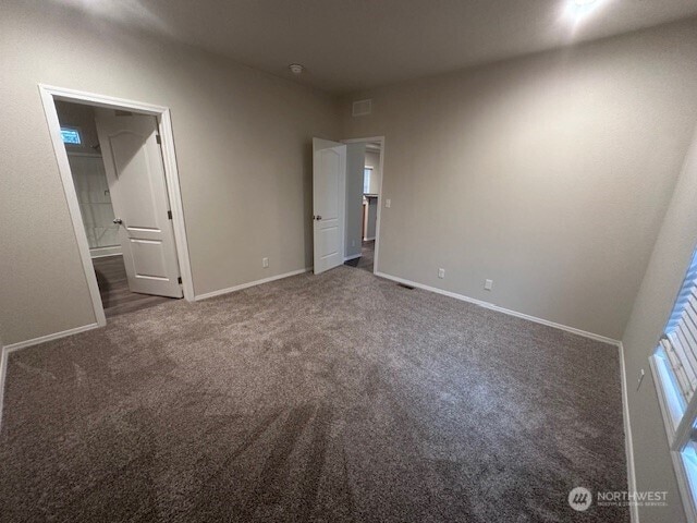 unfurnished bedroom featuring visible vents, baseboards, and carpet