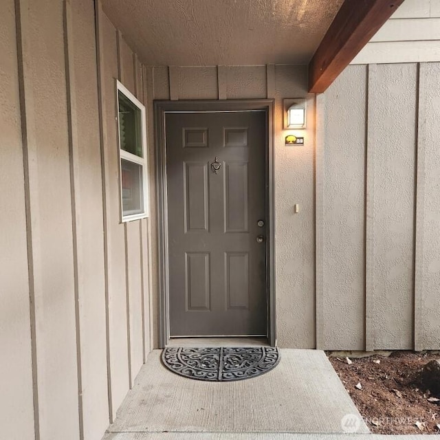 doorway to property featuring board and batten siding