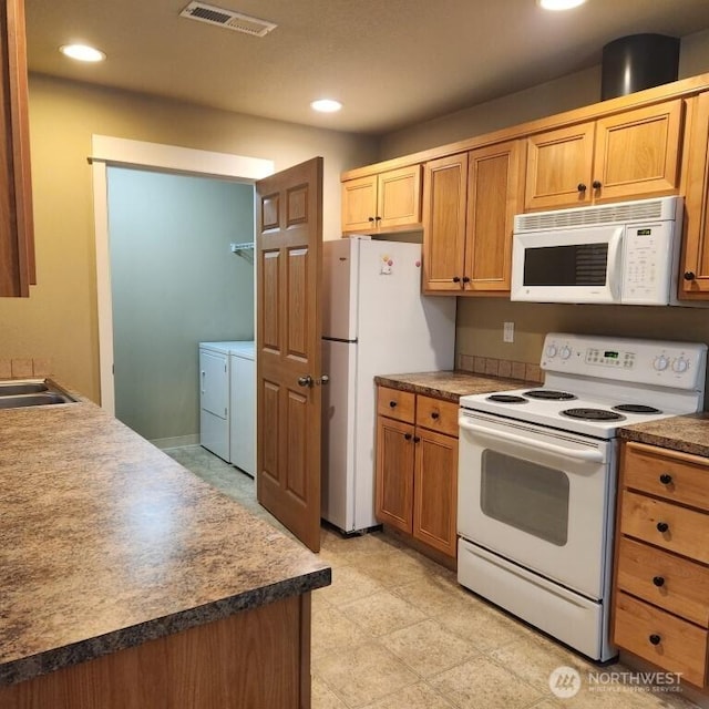 kitchen featuring washer and dryer, white appliances, recessed lighting, and visible vents