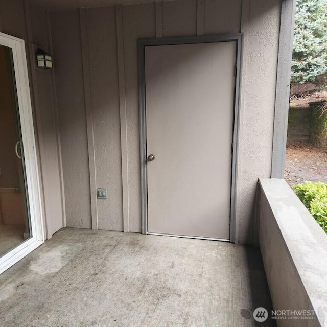 entrance to property featuring stucco siding