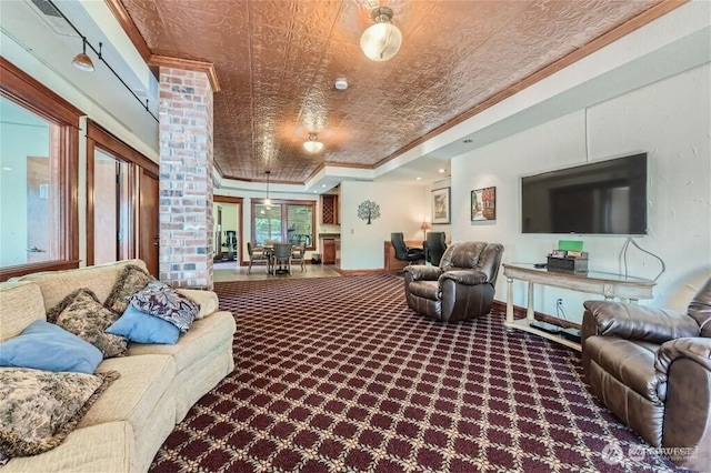 carpeted living room featuring an ornate ceiling, crown molding, and a tray ceiling