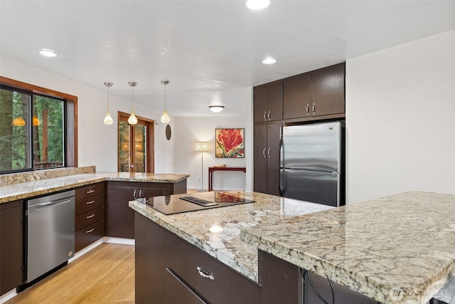 kitchen featuring dark brown cabinetry, light stone counters, recessed lighting, light wood-style flooring, and appliances with stainless steel finishes