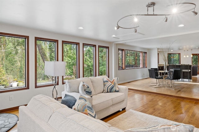 living area featuring light wood finished floors and baseboards