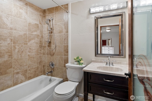 bathroom featuring toilet,  shower combination, and vanity