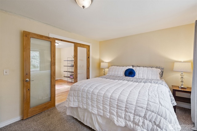 carpeted bedroom featuring baseboards