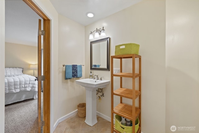 bathroom with tile patterned floors, ensuite bathroom, and baseboards