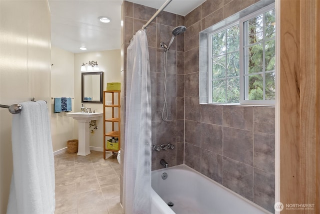 bathroom with tile patterned flooring, baseboards, and shower / bath combo