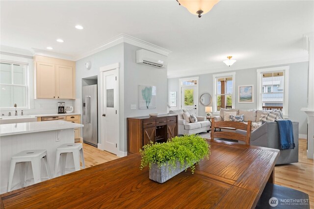 dining space with light wood finished floors, recessed lighting, a wall mounted AC, and ornamental molding