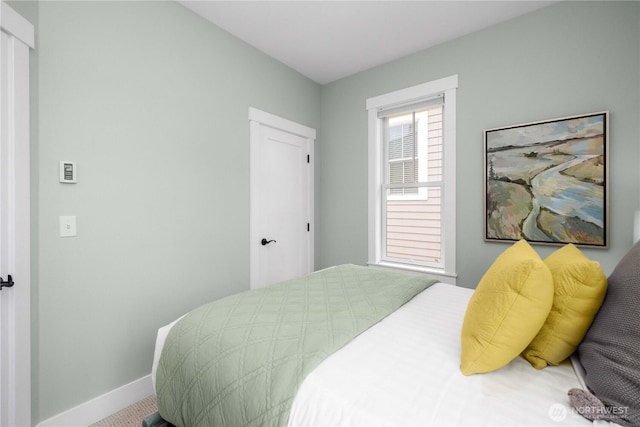 bedroom featuring baseboards and a closet