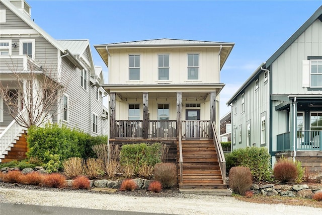 view of front of house with stairway, covered porch, and board and batten siding