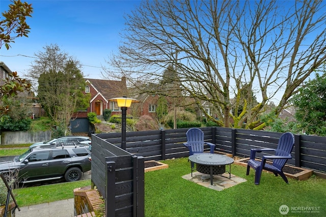 view of yard featuring a fire pit and fence