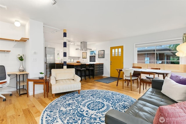 living room with baseboards and wood finished floors