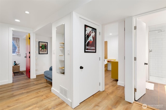 hallway with visible vents, recessed lighting, light wood-type flooring, and baseboards