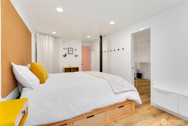 bedroom with recessed lighting and light wood-type flooring