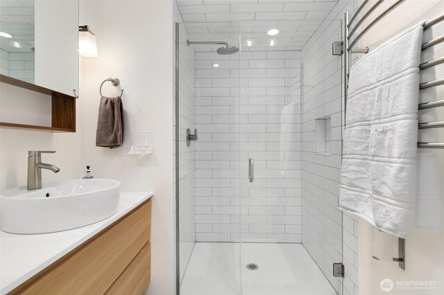 bathroom featuring a stall shower and vanity