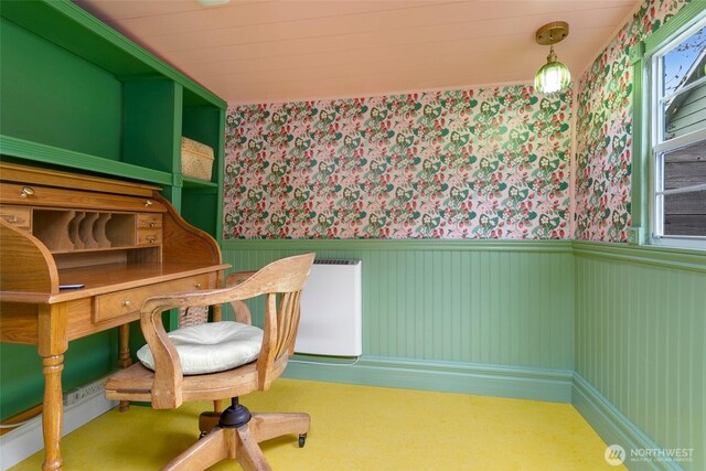 bedroom with radiator heating unit, wainscoting, and wallpapered walls