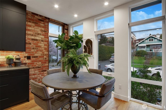 dining space featuring a wealth of natural light, recessed lighting, and light wood finished floors