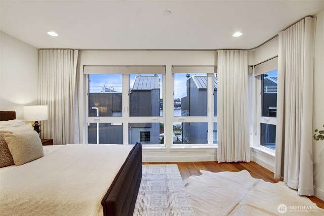 bedroom with recessed lighting and wood finished floors