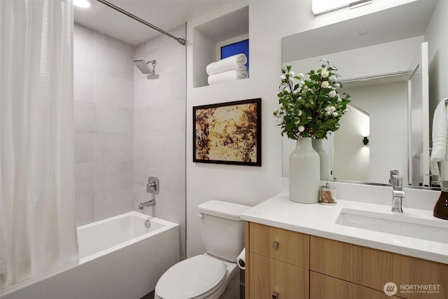 bathroom with vanity, shower / tub combo, and toilet