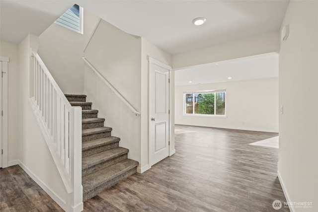 stairway featuring recessed lighting, baseboards, and wood finished floors