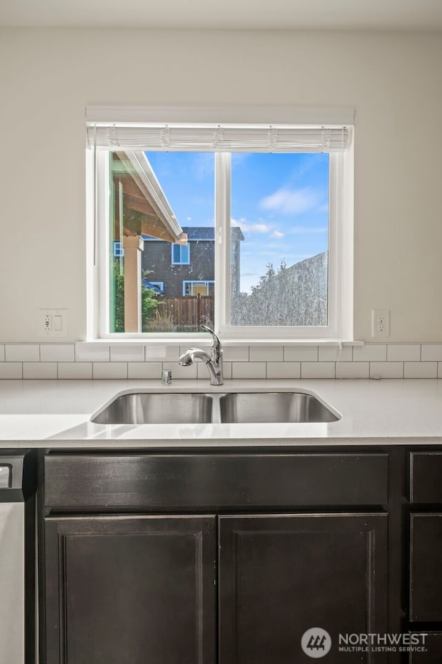 kitchen with light countertops and a sink