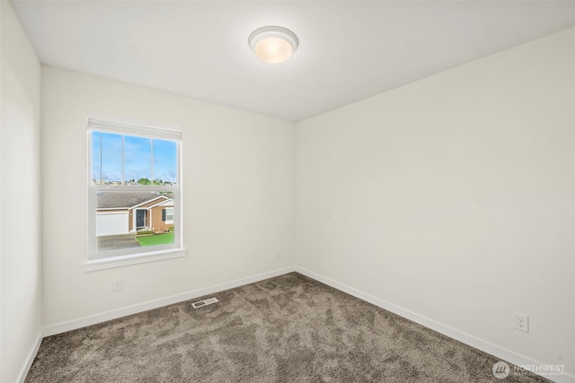 carpeted empty room with visible vents and baseboards