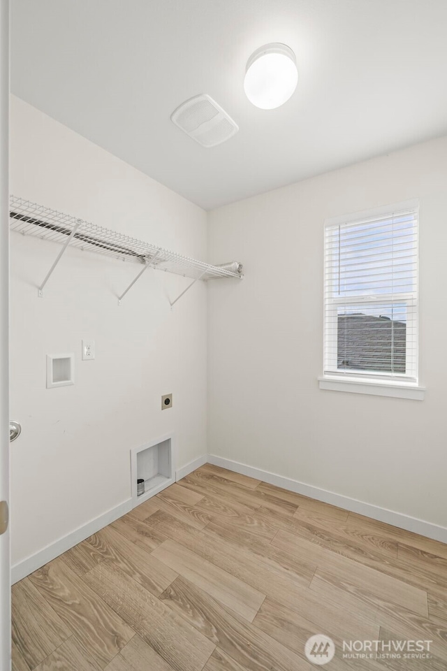 clothes washing area featuring laundry area, hookup for a washing machine, baseboards, and hookup for an electric dryer