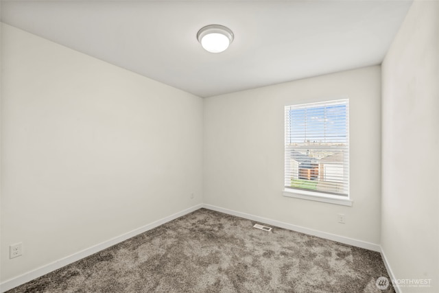 unfurnished room featuring visible vents, baseboards, and carpet flooring