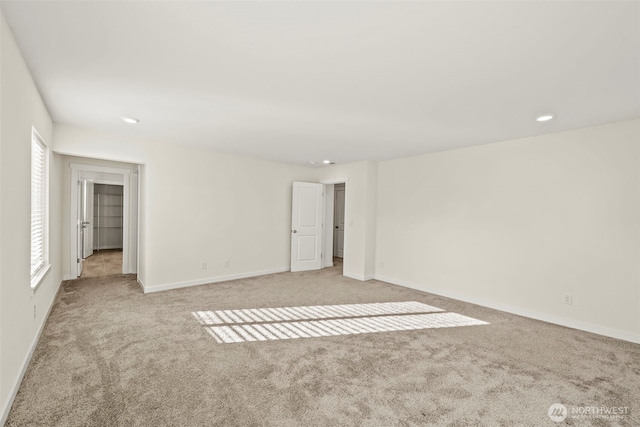 interior space with recessed lighting, baseboards, and light carpet