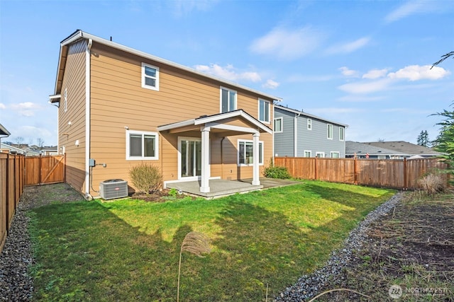 back of house featuring a patio area, a yard, central AC, and a fenced backyard