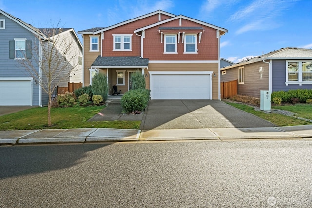 view of front of home with an attached garage, concrete driveway, a front lawn, and fence