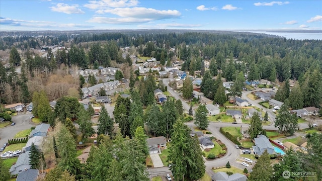 bird's eye view with a forest view and a water view