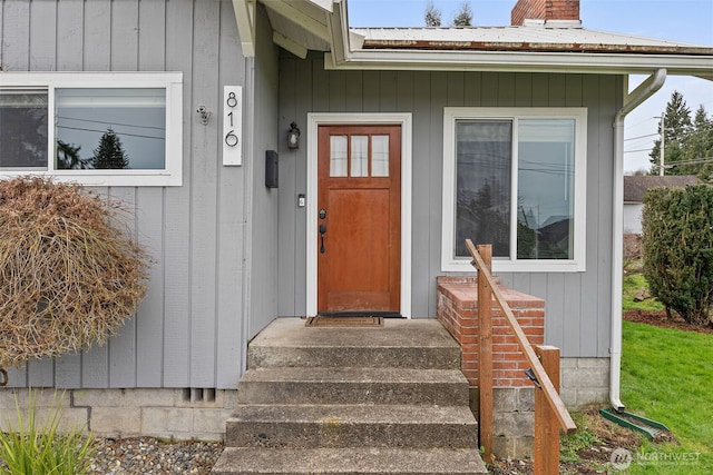 doorway to property featuring a chimney