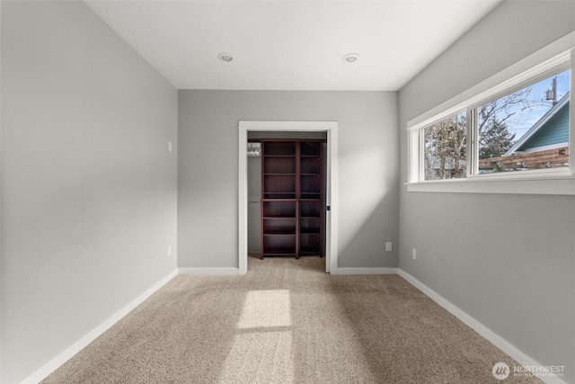 unfurnished room featuring baseboards and carpet floors