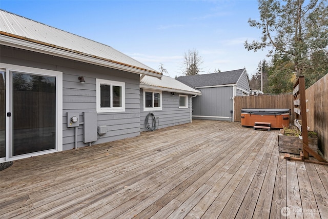 wooden terrace with fence and a hot tub