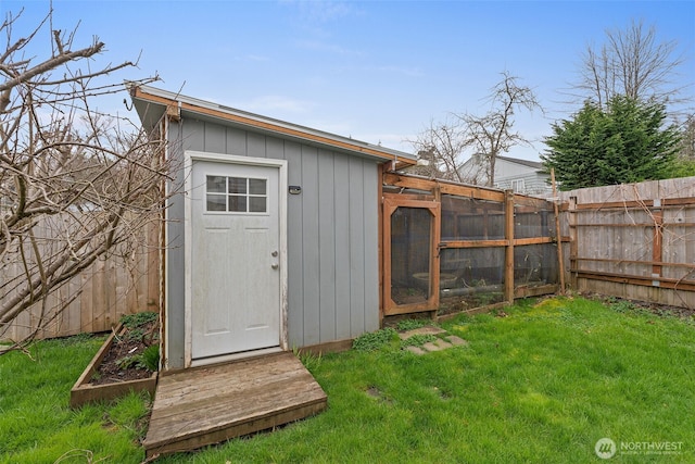 view of outdoor structure with an outbuilding and fence