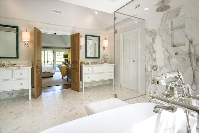 bathroom featuring visible vents, a freestanding tub, a marble finish shower, lofted ceiling, and vanity