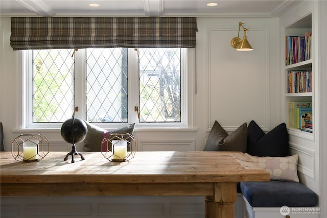 dining area featuring plenty of natural light, built in shelves, and crown molding