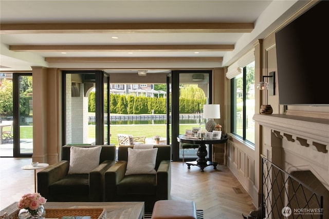 living room with beamed ceiling and a premium fireplace