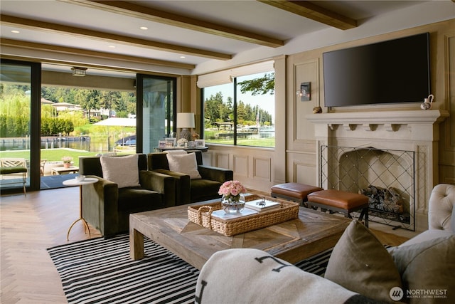 living area with recessed lighting, beamed ceiling, and a fireplace