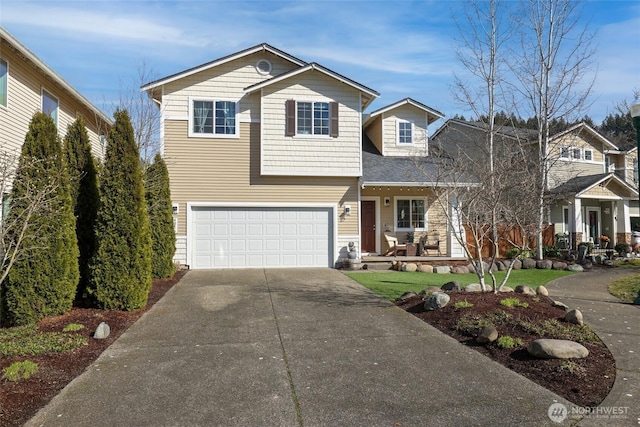 traditional-style home featuring a garage, covered porch, and driveway