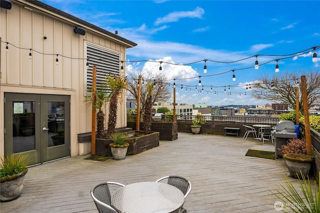 wooden terrace featuring a grill and french doors