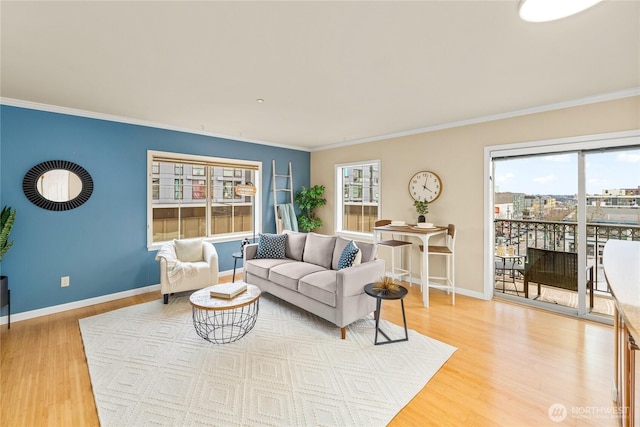 living area with light wood-style flooring, baseboards, and a healthy amount of sunlight