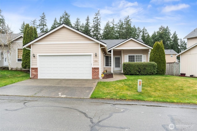 view of front of property with a front lawn, driveway, fence, a garage, and brick siding