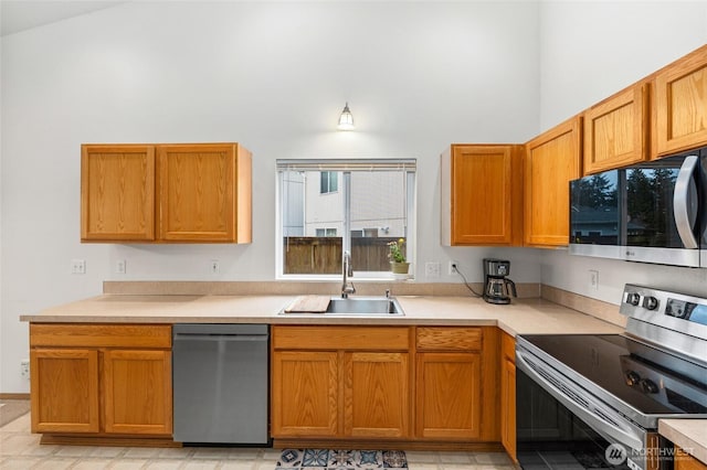 kitchen featuring light countertops, appliances with stainless steel finishes, and a sink