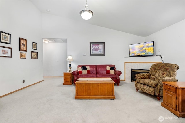 living room featuring light carpet, a fireplace, high vaulted ceiling, and baseboards