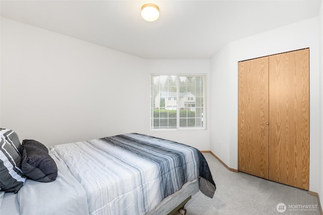 bedroom with baseboards and light colored carpet